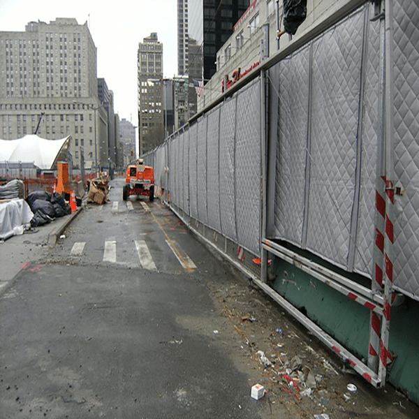 sound blankets hung on construction temporary fence